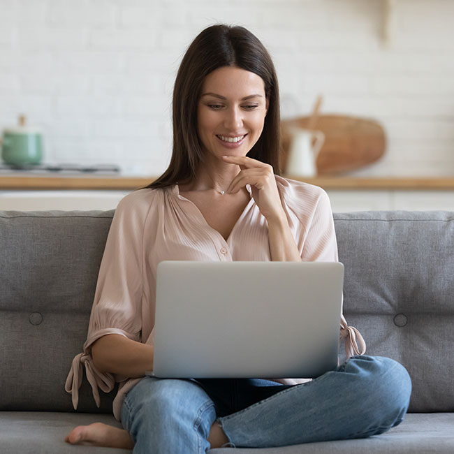 woman on sofa with laptop